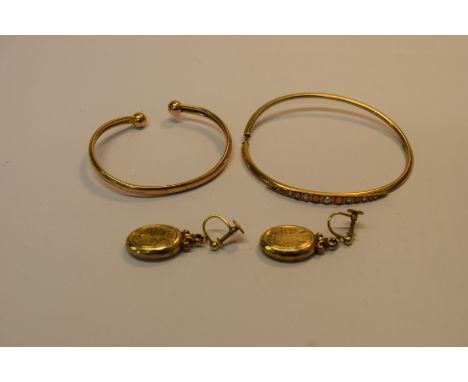 A yellow metal bangle stamped '10'; together with a 9ct gold bangle and a pair of rolled gold screw back earrings.