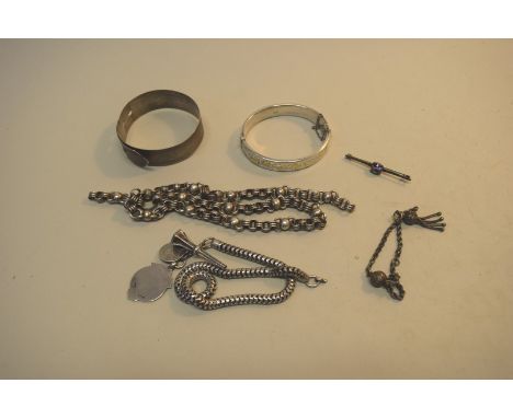 A silver hinged bangle and other silver and white metal items.