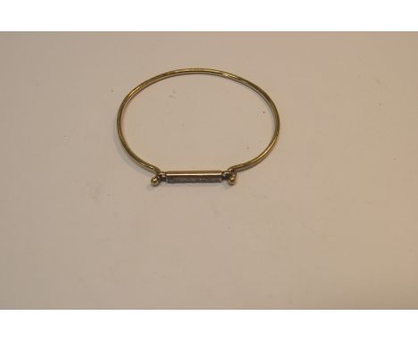 An unmarked 9ct gold and diamond bangle, set eight inline brilliant cut stones. Condition Report: Weight: 8.1g (all in).