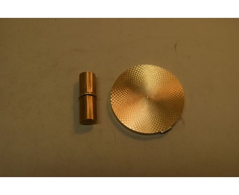 An Asprey 9ct gold engine turned compact, by K W, London 1969, having sapphire set clasp, 7.6cm diameter; together with a mat