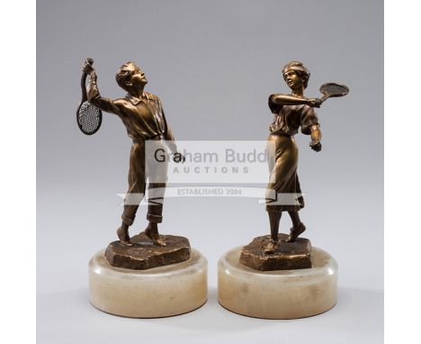A pair of gilt-bronze figures of tennis players circa 1900,signed H. Risch, both on a white marble base, the man's racquet is