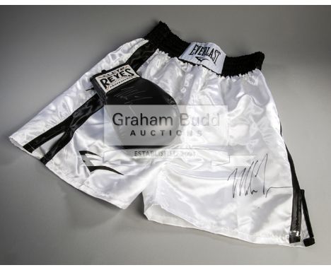 Mike Tyson signed boxing glove and trunks,a black right-hand Reyes glove signed in silver marker pen; together with white & b