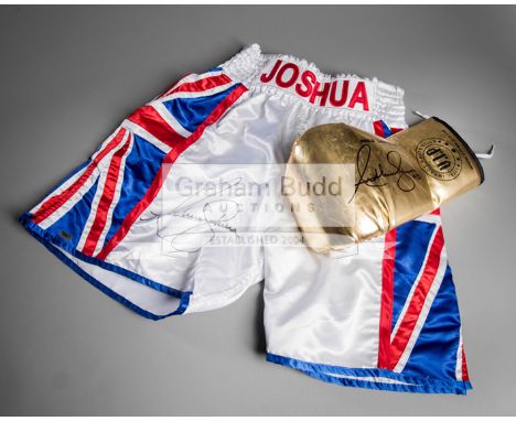 Anthony Joshua signed boxing glove and trunks,a gold left-hand V.I.P glove signed in black marker pen and inscribed A.J, WORL