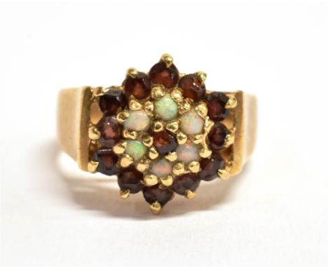 A 9CT GOLD, OPAL AND GARNET GLASS FLOWER HEAD RING The flower head measuring 1.2cm x 1.2cm, the shank hallmarked for Birmingh