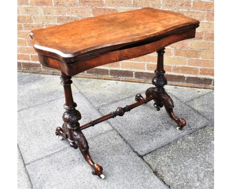 A VICTORIAN BURR WALNUT CARD TABLE  on carved supports united by stretcher, 91cm wide