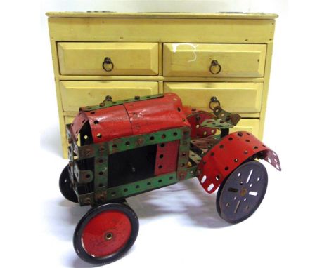 A MECCANO COLLECTION  comprising a constructed model tractor; together with assorted, mainly red and green parts, contained i
