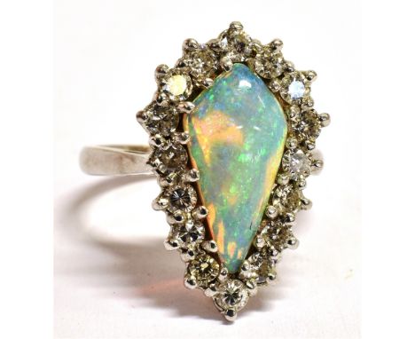 AN OPAL AND DIAMOND MODERN CLUSTER RING  the ring independently assessed as opal, pear shaped cabochon, translucent orange ov