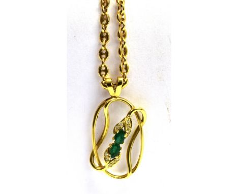 AN 18CT GOLD PENDANT NECKLACE  the open work pendant oval shaped with a raised green and white paste central feature measurin