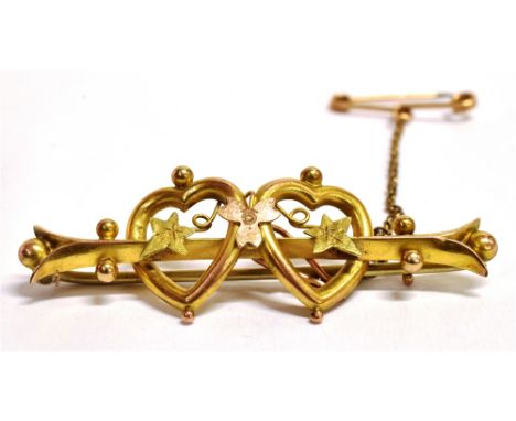 A VINTAGE 9CT GOLD DOUBLE HEARTS BROOCH  the brooch bi coloured gold and set with two open work hearts with floral detail, fa
