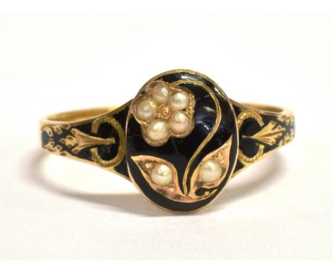 A 15CT GOLD, SEED PEARL AND BLACK ENAMEL PLAQUE RING The oval plaque in black enamel set with a seed pearl flower, with black