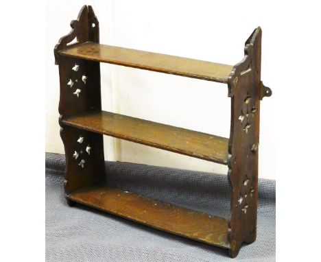 A late Victorian oak hanging shelf, with pierced sides and framed shelves, 50cm high, 60cm wide, 16cm deep.