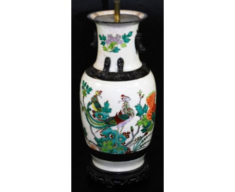 A Japanese pottery lamp vase, of shouldered circular form, polychrome decorated with exotic bird and flowers predominately in