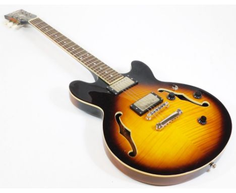A Vintage AV3 small 335 style semi acoustic guitar, having twin humbuckers, rosewood fret board, mother of pearl style inlays