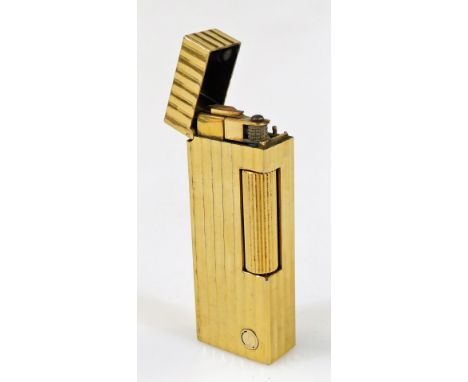 A 20thC Dunhill gold plated pocket lighter, of rectangular form with shaped body, spring loaded lid, marked beneath, 7cm high