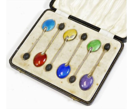 A set of six silver and enamel bean spoons, to include dark blue, light blue, etc. with bean tops, 9cm high, in fitted case. 