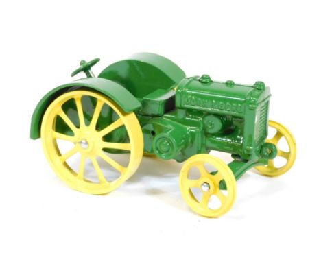 A model of a vintage John Deere tractor, in yellow and green no.0123, 9cm high.