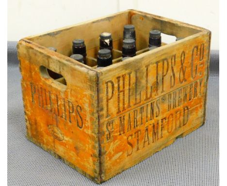 A vintage Phillips &amp; Co bottle crate, containing twelve vacant green glass bottles with Phillips &amp; Co Brewers Stamfor
