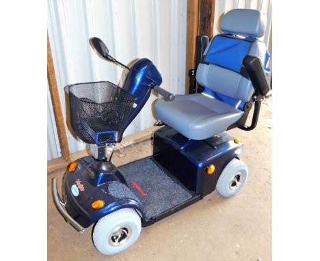 A Freerider 4 wheeled mobility scooter, with front basket, associated bag and grey leather seat, 116cm high.