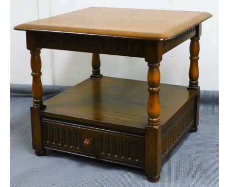 A late 20thC Ercol side table, the shaped top on turned legs with a drawer beneath, 50cm high, 58cm wide, 58cm deep.