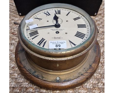 Brass ship's type bulkhead clock marked 'Henry Browne &amp; Son Ltd,' 'Setrel', having Roman numerals and seconds dial on oak