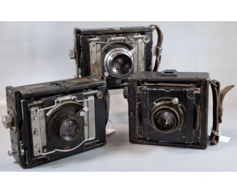 Three vintage bellows plate cameras, with Ross and Dallmeyer lenses. (3)  (B.P. 21% + VAT)