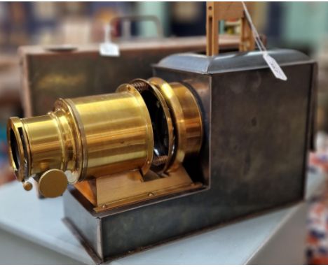 19th century Magic Lantern projector with gilt brass lens, oxidised metal body and original metal carrying box. (2)  (B.P. 21