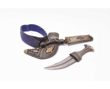 An Omani ceremonial khanjar, believed late 19th/early 20th century, with a horn handle, curved blade with medial ridge, the s