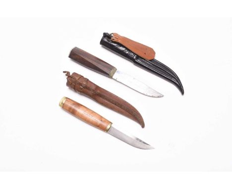 A Kainuun Puukko hunting knife, with hammered 'VL' initials to blade, in a leather sheath with manufacturer markings, blade l