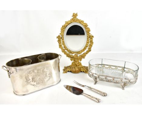 A modern silver plated two sectioned wine or champagne cooler, a brass table top mirror with bevelled plate and a clear glass