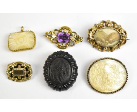 Six 19th century brooches, including two pinchbeck mourning examples, both set with hair, a further brooch set with oval cut 