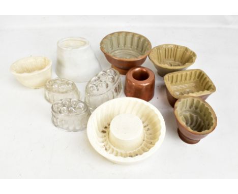 Eleven 19th century jelly moulds comprising seven ceramic, three clear glass and a copper example with patterns including whe