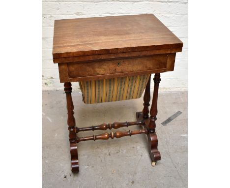 A Victorian burr walnut veneered fold-over games/sewing table, the hinged lid enclosing inlaid chess and backgammon boards, w