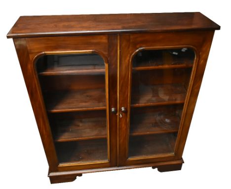 A Victorian mahogany bookcase with twin glazed doors, raised on bracket feet, width 114cm.Additional InformationTop and base 