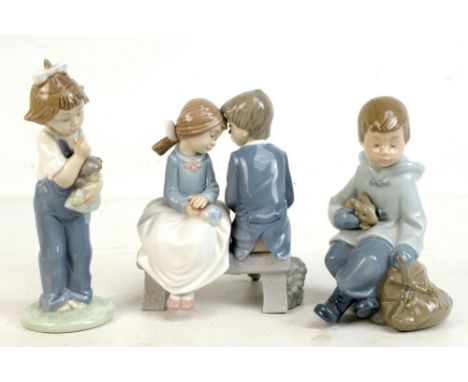 NAO; three ceramic figurines including 'Lovers Seated on a Bench', height 16cm, a girl holding a doll, height 18cm, etc (3).A