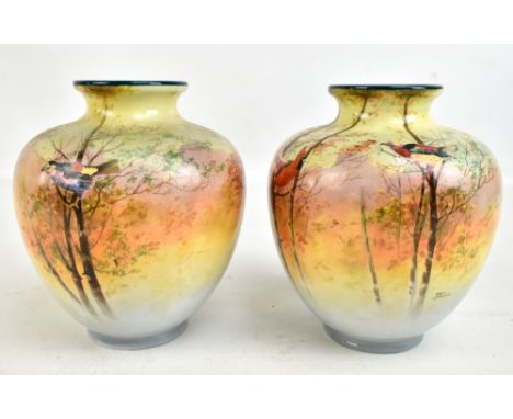 JACK PRICE FOR ROYAL DOULTON; a pair of vases painted with birds perched on branches, both signed J. Price, with green printe