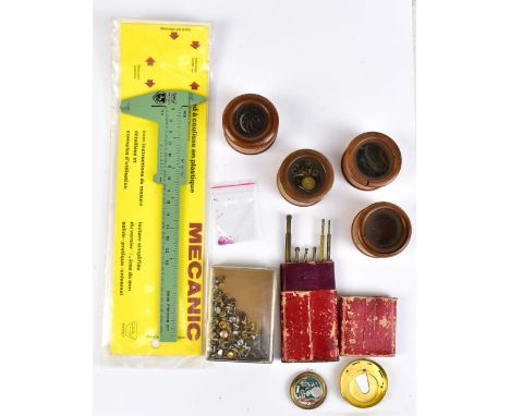 Agroup of pocket watch tools and loose components including balance wheels,small screws, etc.