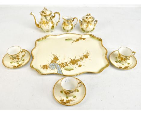 LIMOGES; a part tea service with gilt foliate decoration comprising tea pot, sugar bowl with lid, cream jug, three cups, thre