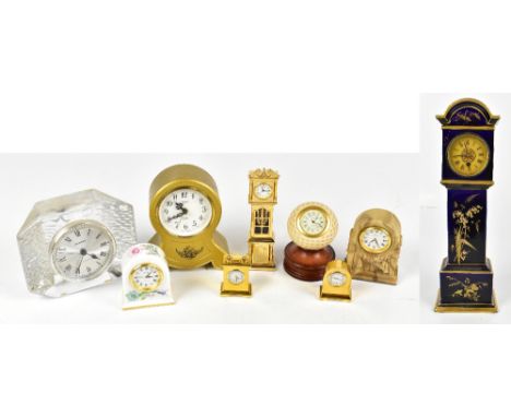 An Aesthetic Movement blue ceramic miniature longcase clock, the gilded dial set with Roman numerals, inset between gilded hi