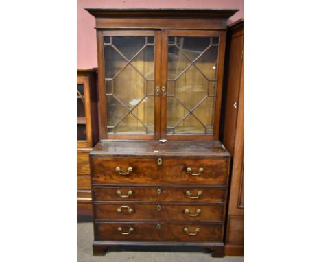 A George III mahogany secretaire bookcase, the later upper section with twin astragal glazed doors, the lower with replacemen