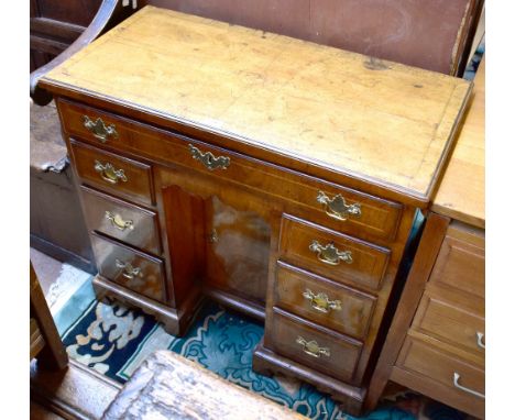 A late George II/early George III walnut crossbanded and line inlaid kneehole desk with frieze drawer above two banks of thre