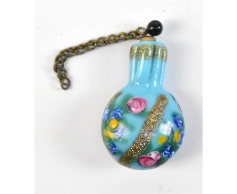 A miniature scent bottle with enamelled floral and gilt detail, with stopper, length 3.2cm, with pink silk pouch (pouch af).A