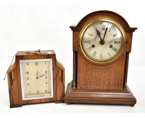 An Edwardian oak and boxwood strung eight day mantel clock, the circular silvered dial set with Roman numerals, height 34cm, 