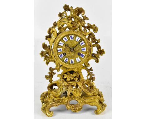 RAINGO FRERES; a mid 19th century French ormolu mantel clock with applied scrolling and floral detail surrounding a circular 