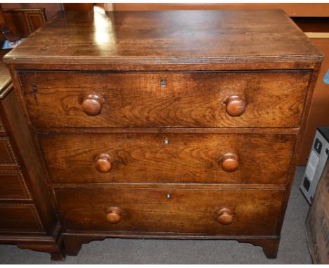 An early 19th century oak straight front chest of three drawers, raised on bracket feet, height 93cm, length 91cm, depth 50cm