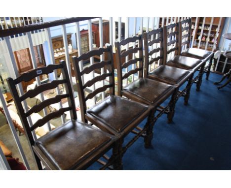 Six oak ladder-back chairs