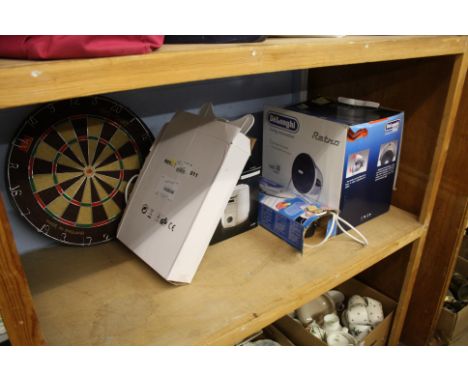 Shelf of assorted including dartboard etc.