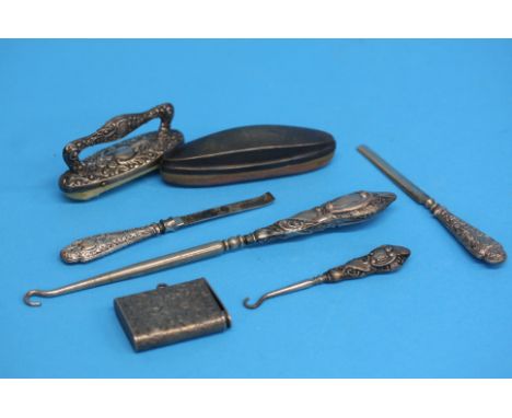 A small silver engraved vesta case, a silver mounted button hook etc.