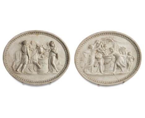 A rare pair of  Coade stone oval plaqueslate 18th centurymodelled in relief with a Roman sacrifice of a bull and Cupid being 