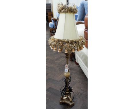 A tall onyx and gilt table lamp with fringed shade 