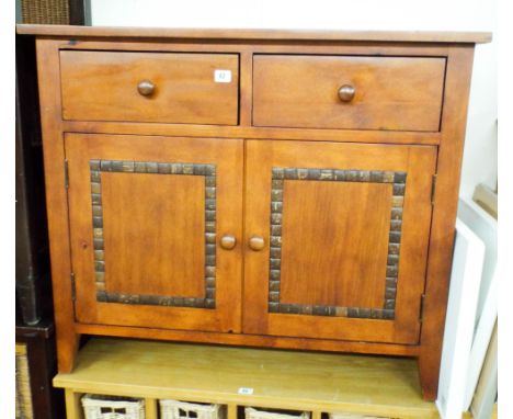 A modern hard wood cabinet with decorative tile inlays 